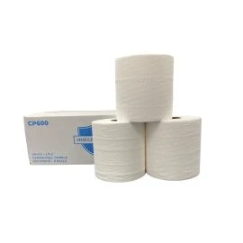 Rolls of center pull towels in front of their box.